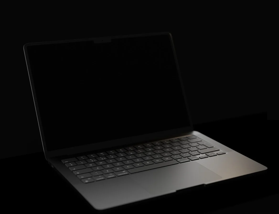 The MacBook on the desk in the studio, typing the code that moves the camera through the room on this site